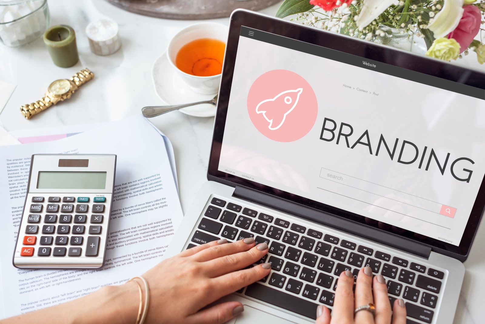Person working on re-branding strategy on a laptop