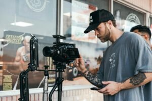 An aspiring creator adjusting camera setup during shoot