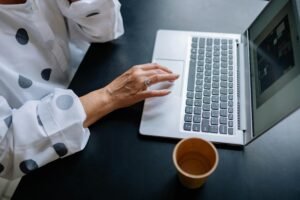 Human strategist working on AI brand strategy automation using a laptop